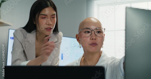 Professional Asian executives share expertise and guidance during a project briefing. Focused on corporate partnership, management strategy, and togetherness in a modern office.