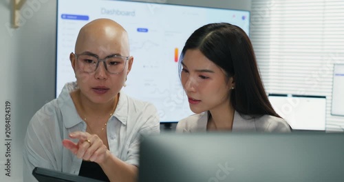 Asian businesswomen talking and presenting ideas. Teamwork and collaboration during a project briefing to ensure successful marketing strategy and professional cooperation.
