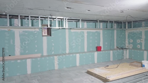 Room renovation with drywall wall covering and metal frame on the ceiling