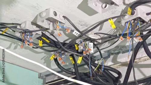 Complex electrical wiring with corrugated cable ducts and tags during network installation