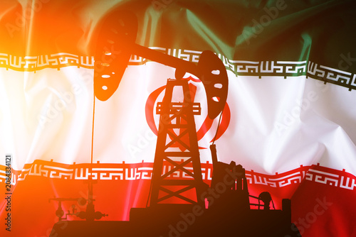 Silhouette an oil pump jack against waving flag Iran. Energy crisis concept.