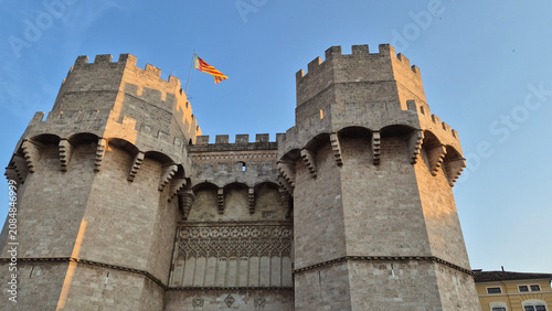 Historic stone castle gate towers under blue sky