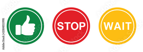 Fotografie Traffic Signal Icons: A set of three circular icons representing traffic signals: a green icon with a thumbs-up symbol, a red icon with the word STOP, and a yellow icon with the word WAIT