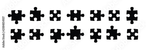 Φωτογραφία Puzzle Pieces Arranged: A collection of black puzzle pieces, each with unique interlocking tabs and slots, are displayed in two neat rows, symbolizing connection and problem-solving