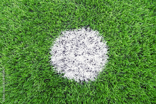 Green artificial football field white penalty mark synthetic grass texture creating clean sports background for soccer themes