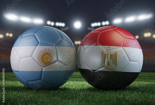 Two soccer balls in flags colors on a stadium blurred background. Argentina vs Egypt.