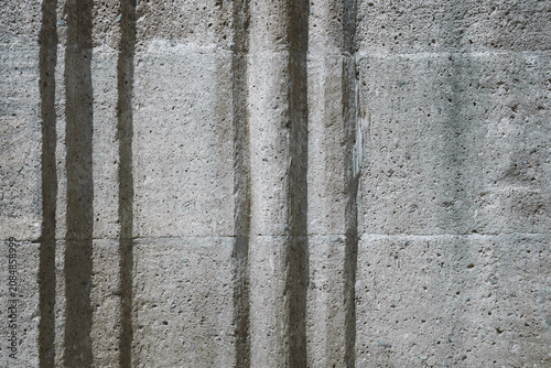 Sandstone block wall with decorative architectural elements featuring natural stone texture