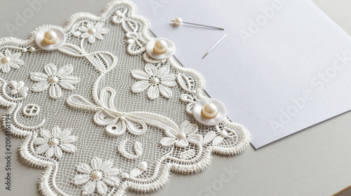 Lace swatches with satin ribbon, pearl buttons and pins