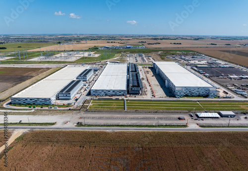 Aerial view of a large data center campus in Hutto, Texas, with three massive buildings with 400M square feet of space and 600MW power capacity