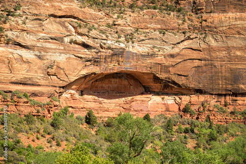 Large natural blind arch indentation in a sandstone cliff face in Zion National Park