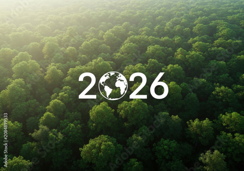 Aerial view of lush green forest with a white 2026 and globe icon symbolizing environmental focus on future.