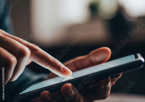 Close up of finger touching smartphone screen showing technology interaction and digital communication in modern life.