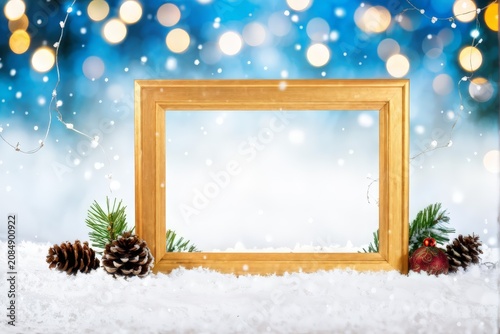 Snowy Wonderland: Blurred Lights Frame Capturing Pine Cones and Holiday Decorations Inside a Wooden Photo Frame
