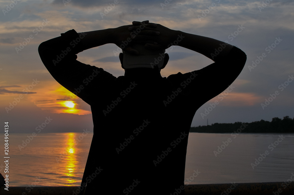 Fototapeta premium Silhoette man at beach at sunset