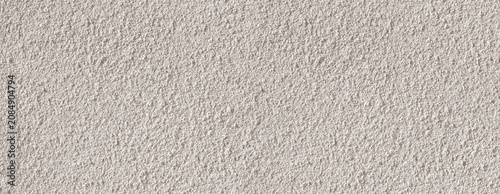 Rough beige stucco wall surface texture background