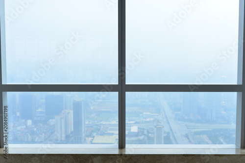 Obraz na plátně Interior observation area with large panoramic windows overlooking an urban landscape