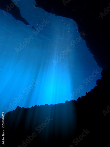 Cathedrals of light. Underwater photo of a dreamlike and etheral environment. From cave scuba dive in rays of sunlight. Unspecified.