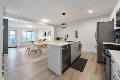 Modern open concept kitchen interior with white cabinetry and large island interior residential countertop cabinetry flooring stainless appliances lighting spacious
