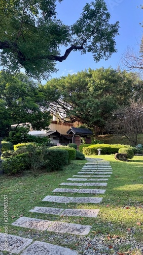Stepping stone path through a manicured traditional garden