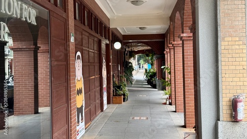 Quiet covered walkway beside historic red brick shops