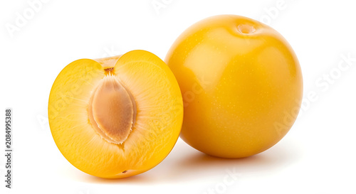 Yellow plum cut in half with whole plum fruit food