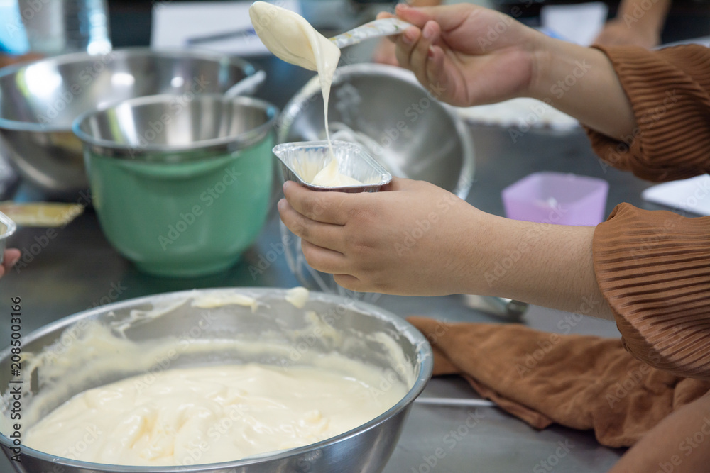 Fototapeta premium Woman baking in the kitchen