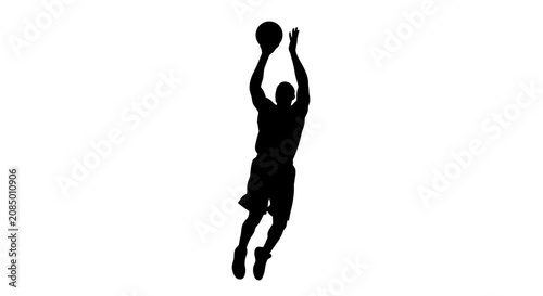 Fotografie Basketball player silhouette reaches upward to perform a jump shot during a high-stakes game