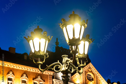 Fotografie Vintage street iron lamp in the center of Novi sad in Serbia at night