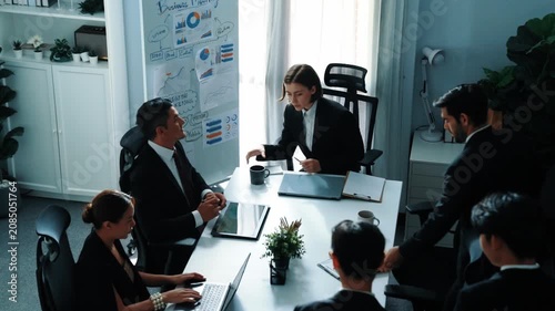 Business people sitting at seat and prepare for meeting at whiteboard with colorful sticky notes and mind map. Professional diverse group talking about marketing plan at meeting room. Directorate.