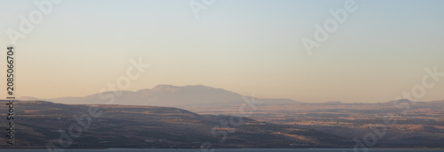 Canvas Print Panoramic view of hazy desert mountains across the Sea of Galilee during a soft