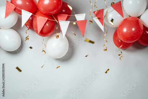 Festive celebration background with red and white balloons and hanging bunting flags on a neutral surface balloons celebration decoration confetti background birthday