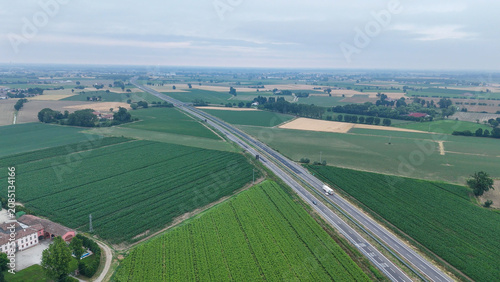 Obraz na plátně Aerial establishing shot showcasing the vast agricultural fields with prominent garlic crops growing in the Po Valley