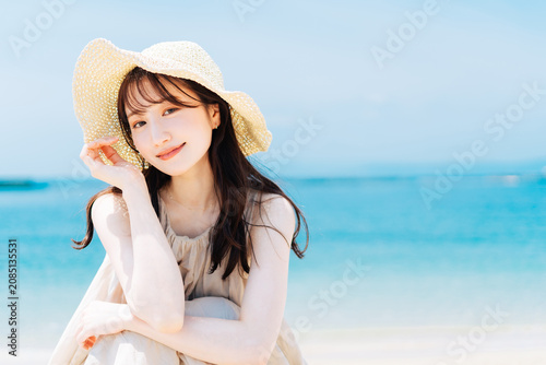 海と青空を背景にした女性