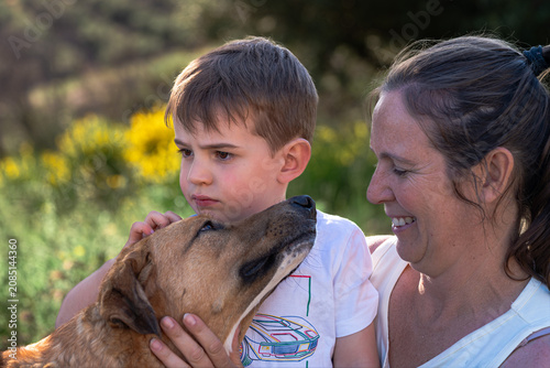Mother, son, dog enjoying outdoor family moment
