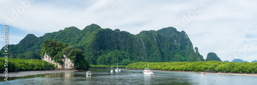 Amazing view of beautiful beach and boat with with mountains. Beautiful natural panoramic countryside landscape at sea in Thailand.