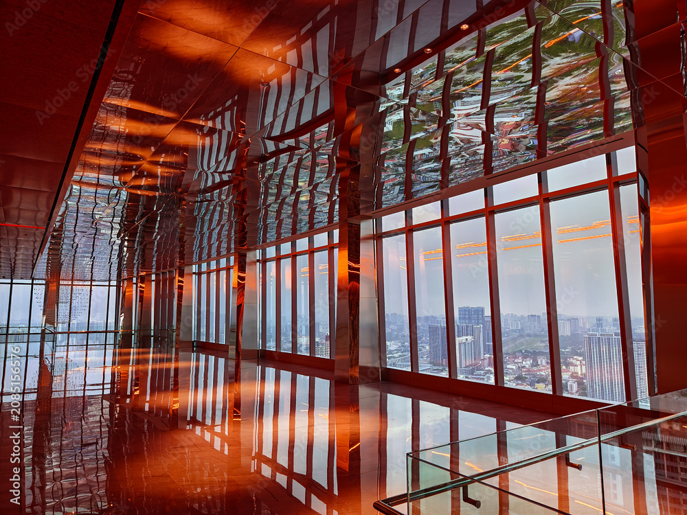 Obraz premium Spacious glass atrium with reflections on polished floor and panoramic windows. Empty lobby features