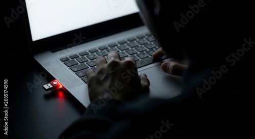 Person working on laptop computer late.