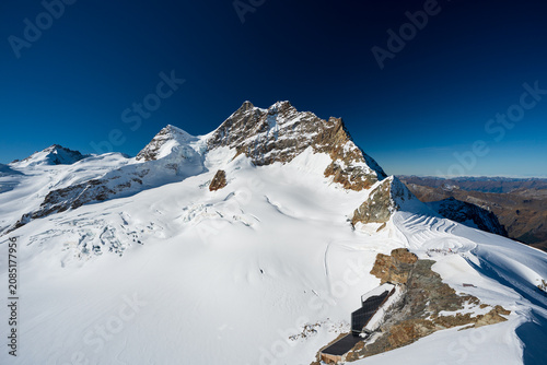 Jungfrau mountain peak and glacier under clear sky. Jungfraujoch, Canton of Bern, Switzerland.