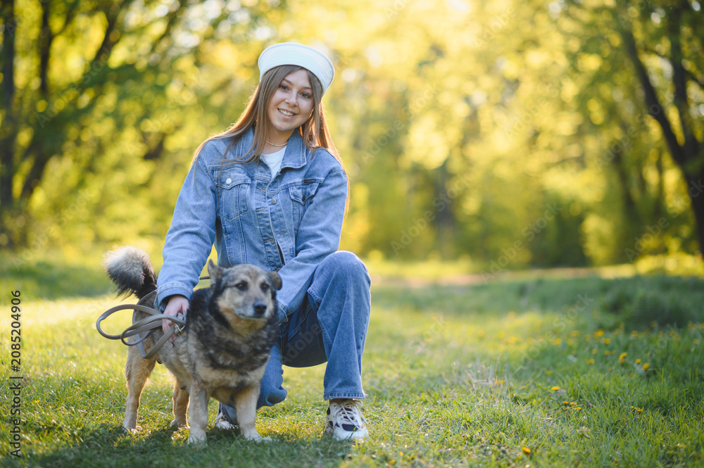 Fototapeta premium Young woman bonding with dog in park