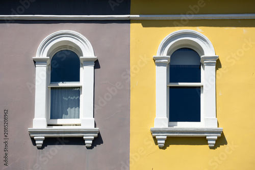 Colorful building facade with two arched windows in London, Notting Hill.