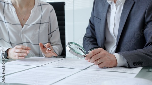 Tableau sur toile Business professionals reviewing legal contracts and important documents with a