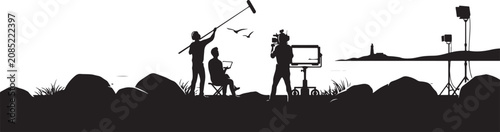Canvastavla Film crew silhouetted against setting sun capturing coastal scene magic