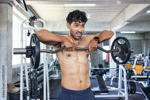 Athlete Performing Upright Row with Barbell