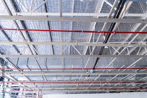 Exposed ceiling with HVAC ducts and fire sprinkler pipes