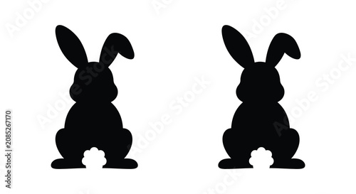 Bild auf Leinwand Two rabbit silhouettes one black and one green against a white background silhou