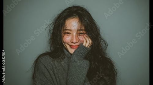 Elegant Korean crying face brown long hair , wide minimal studio, Korean portrait, joyful concept.