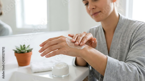 Woman Applying Hand Cream for Skincare. Daily Moisturizing Routine for Healthy Skin. Beauty Product & Self-Care.