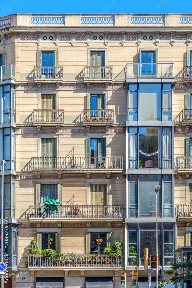 Obraz premium Classic Residential Building Facade with Green Shutters and Balconies in Barcelona, Eixample District Architecture