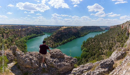 Man exploring hoces del duraton canyon in segovia, enjoying scenic panorama view of winding river
