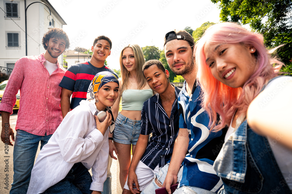 Fototapeta premium Group of multiethnic teenagers spending time outdoor and having fun